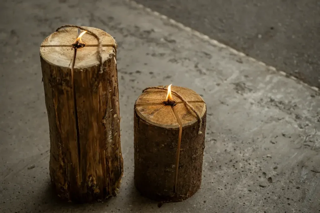 Finnenkerze, 25 und 50 cm, oben gewinkelt mit sichtbarer Flamme und brennendem Holz